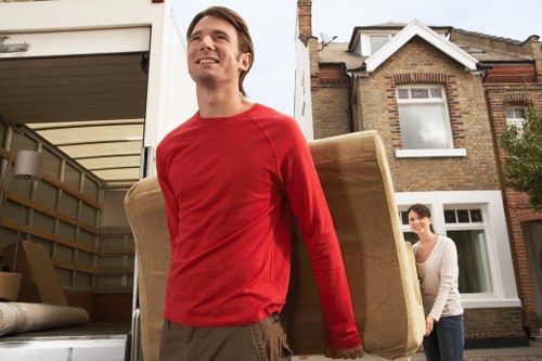 Packed household items being loaded into a van