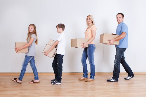 Professional team organising boxes and fragile items during a Waddon move